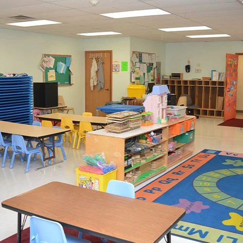 Inside the Head Start Classroom we see toys and play mats and desks for learning