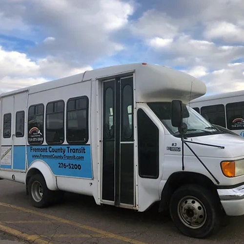 A Fremont County Transit shuttle bus parked in a parking lot