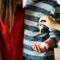 Couple accepting house keys from a real estate agent